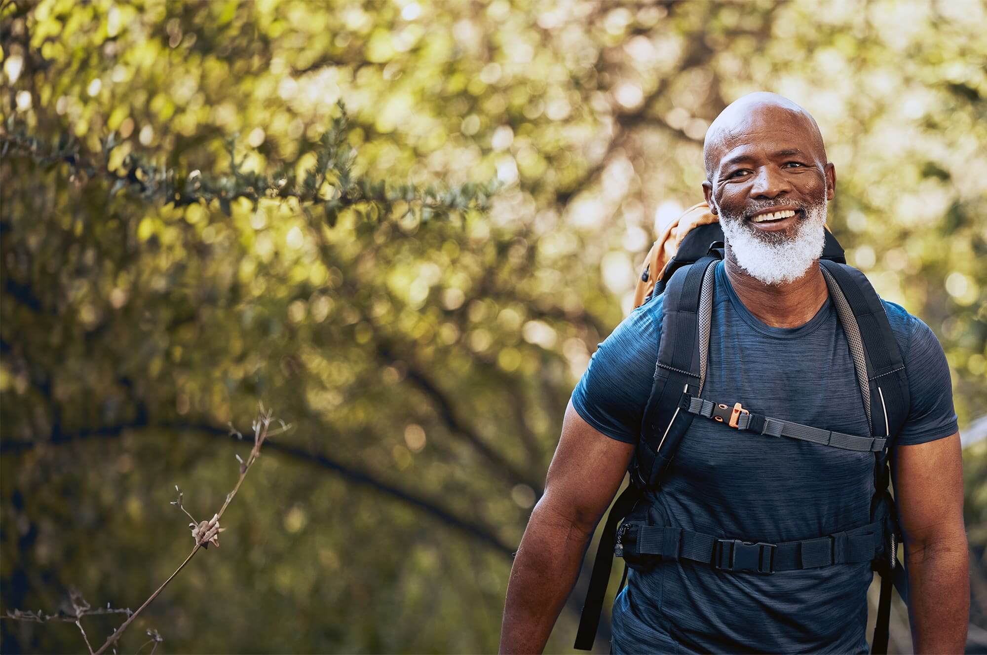 Active older man hiking in a forest